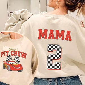 a woman wearing a sweatshirt with the number two on it