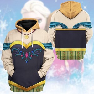 A hooded sweatshirt with a design featuring a woman's face and a floral pattern. The hood is yellow and the sweatshirt is white with blue and green accents.