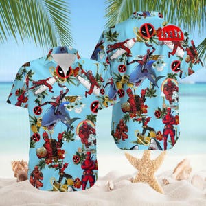 May include: Light blue short-sleeved button-down shirt featuring a repeating pattern of the Deadpool character, sharks, and tropical elements. The shirt has a classic collar and a relaxed fit, perfect for casual wear.