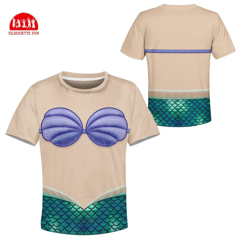 May include: A beige t-shirt featuring a mermaid design. The front of the shirt displays a blue seashell bra and a green scale pattern. The back of the shirt has a blue stripe and a green scale pattern. The logo "SILHOUETTE FUN" is in the upper left corner.