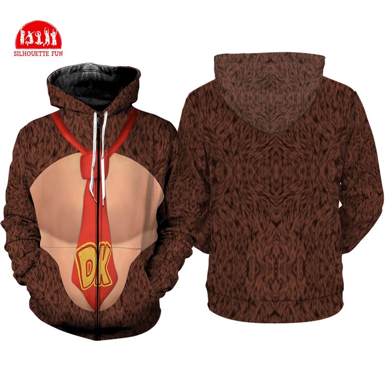 May include: Brown zip-up hoodie with a design resembling a cartoon character. The front features a tan chest with a red tie and the letters "DK" in yellow. The sleeves and hood are brown, mimicking fur. The back of the hoodie is also brown.