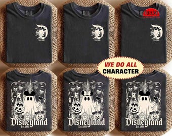May include: A charcoal gray t-shirt featuring a white graphic of a ghost wearing mouse ears and holding a pumpkin. The design includes the text Disneyland Est. 1955, a castle, spiderwebs, and bats. The shirt is displayed in multiple views.