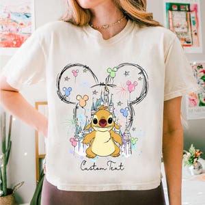 a woman wearing a mickey mouse shirt