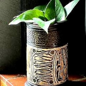 May include: A white ceramic mug with a black handle and the text "But First, Coffee" in a bold, black font. The mug is displayed on a white surface, showcasing its clean design.