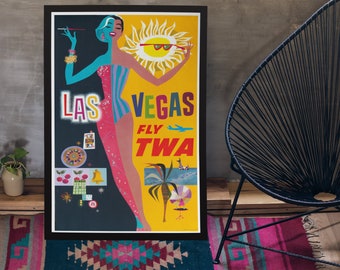 May include: A framed vintage-style travel poster for Las Vegas featuring a split-color illustration of a person in a striped swimsuit. The text reads LAS VEGAS FLY TWA, accompanied by graphics of a sun, a roulette wheel, cherries, and a palm tree.