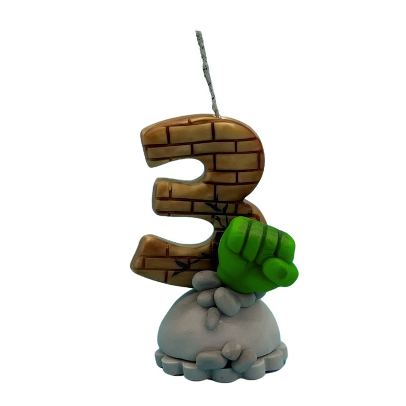 Handmade birthday candle character inspired, brick texture on clay handmade number age, with grey base and sculpted rocks and green hand. cake topper for birthday decor, boys birthday party, personalized keepsakes