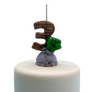 Handmade birthday candle character inspired, brick texture on clay handmade number age, with grey base and sculpted rocks and green hand. cake topper for birthday decor, boys birthday party, personalized keepsakes