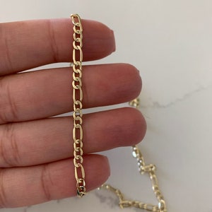 May include: A set of three ceramic vases in varying heights and shapes. The vases are glazed in a matte white finish, offering a minimalist aesthetic. The tallest vase is approximately 10 inches high.