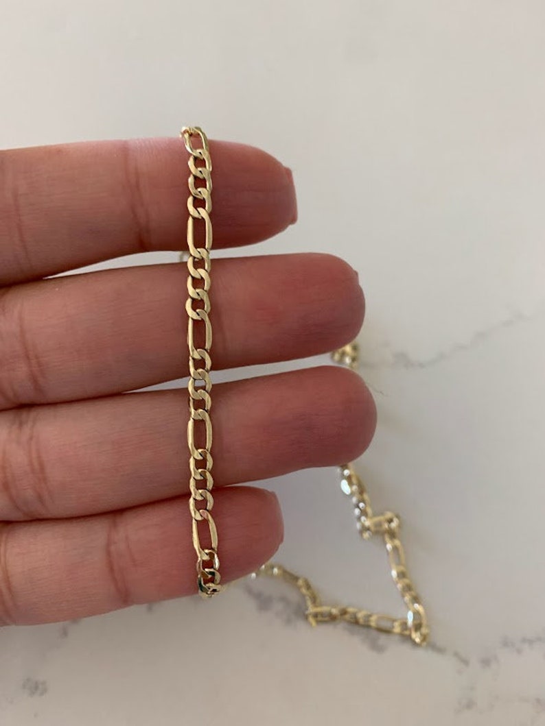 May include: A set of three ceramic vases in varying heights and shapes. The vases are glazed in a matte white finish, offering a minimalist aesthetic. The tallest vase is approximately 10 inches high.