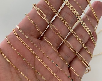 May include: A collection of gold chain necklaces of varying lengths and styles, including a curb chain, a rope chain, a box chain, and a figaro chain.
