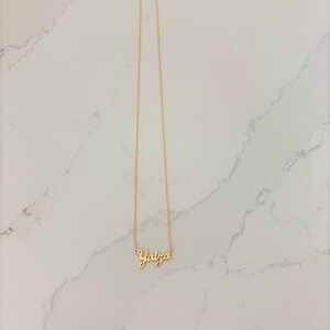 May include: A gold chain necklace with the name "Yaiza" spelled out in cursive.