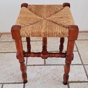 Vintage wooden stool with reed seat