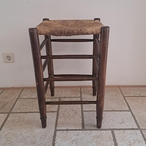 Vintage wooden stool with reed seat