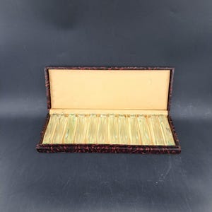 Set of twelve crystal knife rests in original box