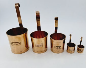 Set of five antique Dutch brass measuring cups