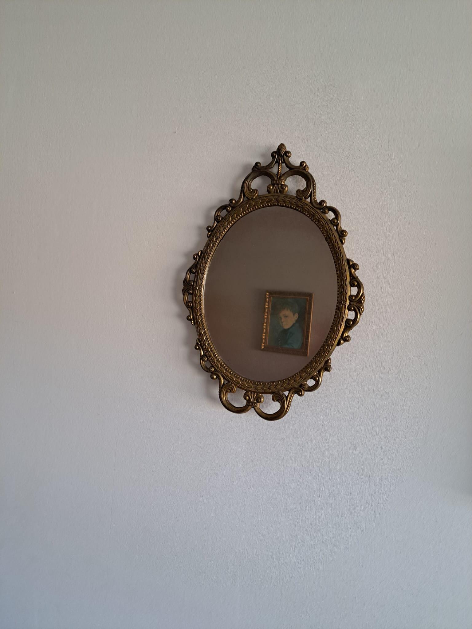 Vintage oval baroque brass mirror