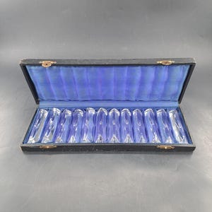Set of twelve crystal knife rests in original box