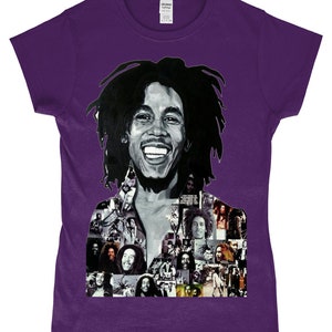 May include: Purple t-shirt featuring a black and white photo collage of Bob Marley. The collage includes a large image of Marley smiling with his iconic dreadlocks. The background of the collage is made up of smaller images of Marley in different poses.
