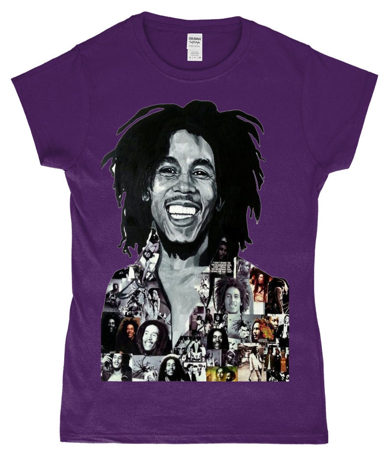 May include: Purple t-shirt featuring a black and white photo collage of Bob Marley. The collage includes a large image of Marley smiling with his iconic dreadlocks. The background of the collage is made up of smaller images of Marley in different poses.