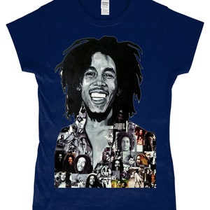 May include: A navy blue t-shirt featuring a black and white photo collage of Bob Marley. The collage includes various images of Marley, including a close-up of his face with a wide smile.