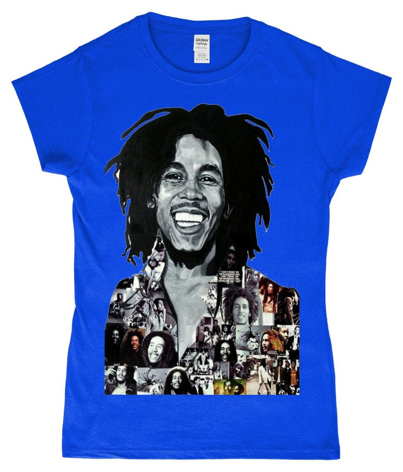 May include: A royal blue t-shirt featuring a black and white photo collage of Bob Marley. The collage includes a large image of Bob Marley smiling with his signature dreadlocks.