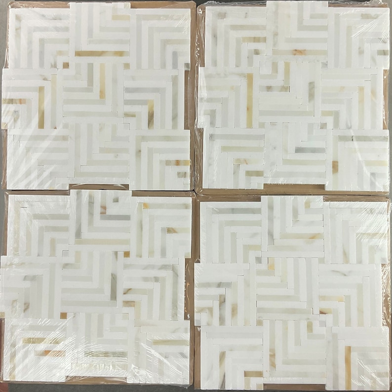 May include: Four white marble mosaic tiles with a geometric pattern. The tiles are arranged in a square shape and are packaged in plastic wrap.