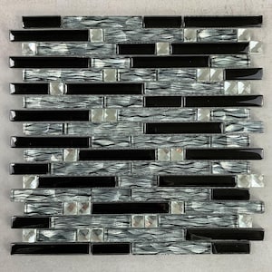 May include: A mosaic tile sheet featuring a mix of black, silver, and clear glass tiles. The design incorporates rectangular black tiles, wavy silver tiles, and square clear glass accents, creating a textured, modern look.