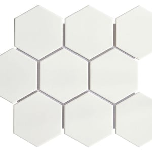 May include: A sheet of white ceramic hexagonal tiles. The tiles are arranged in a honeycomb pattern.