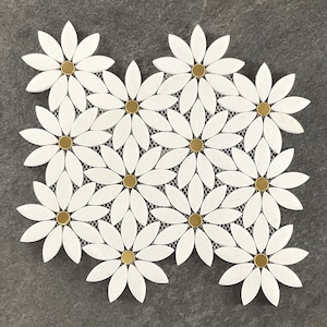 May include: White marble mosaic tile sheet featuring a daisy flower design with gold accents. Each flower has 10 petals and a gold center.