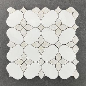 May include: White marble mosaic tile with a floral pattern. The tiles are arranged in a grid pattern and have a slightly raised, textured surface.