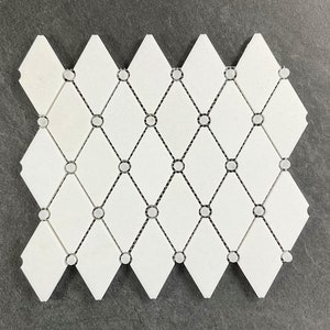 May include: White diamond-shaped ceramic tiles with black grout lines and small white circles at the intersections of the grout lines.