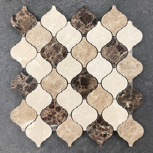 May include: A mosaic tile sheet with a geometric pattern of brown, beige, and white marble tiles. The tiles are shaped like a quatrefoil, a four-lobed shape.