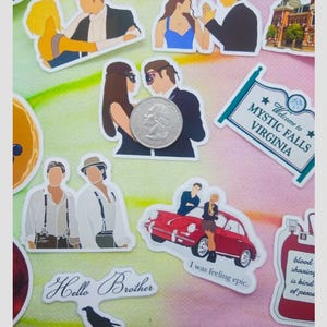 May include: A collection of stickers featuring various designs. Some stickers depict couples, a red car, and a sign that reads "Welcome to Mystic Falls Virginia." Other stickers include the text "Hello Brother" and "I was feeling epic."