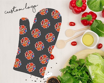 May include: A gray oven mitt with a repeating pattern of red and blue firefighter emblems. The emblems feature a crossed axe and hose, a letter "P", and the year "1960".
