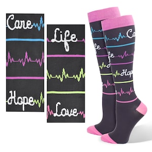 May include: Pair of black knee-high socks with pink and white accents. The socks feature a repeating pattern of EKG lines with the words "Care", "Life", "Hope", and "Love" written in white.