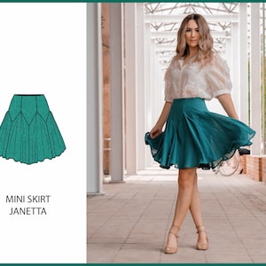 Może przedstawiać: Turkusowa mini spódnica o rozkloszowanym kroju. Spódnica jest pokazana na modelce w białej bluzie, która stoi na korytarzu.