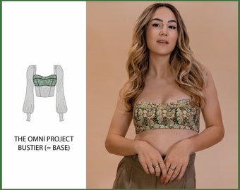 May include: A green and white floral print bustier top with a fitted bodice and long sleeves. The top is shown on a model with a neutral background. The text "THE OMNI PROJECT BUSTIER (= BASE)" is displayed below the image.