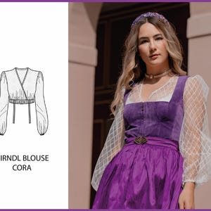 May include: A white dirndl blouse with long sleeves and a V-neckline. The blouse has a wrap-style design and a cropped length. The text "DIRNDL BLOUSE CORA" is printed below the image.