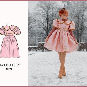 May include: A pink babydoll dress with a white collar and gold trim. The dress has puffed sleeves and a full skirt. The dress is being worn by a person in a snowy outdoor setting.