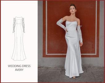 May include: A white wedding dress with a fitted bodice and a flowing skirt. The dress has a strapless neckline and long lace sleeves. The dress is shown on a model standing in front of a red wall.