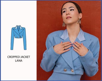 May include: A light blue cropped jacket with a double breasted closure and a white collar. The jacket is shown on a model against a red background. The text "CROPPED JACKET LANA" is below the image.