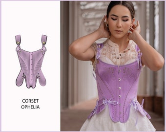 May include: A lavender corset with a lace-up front and a decorative bow at the bottom. The corset is called "Ophelia" and is shown on a model.