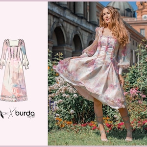 May include: A woman wearing a pink and white floral dress with a square neckline and long sleeves. The dress has a fitted bodice and a full skirt. The woman is standing in a garden with flowers.