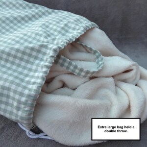 Handmade laundry bag in a light sage green gingham cotton rich canvas fabric with white cotton braided cords.

Extra large with drawcord and carry handles - 51cm x 45cm.  This size held a double throw blanket.