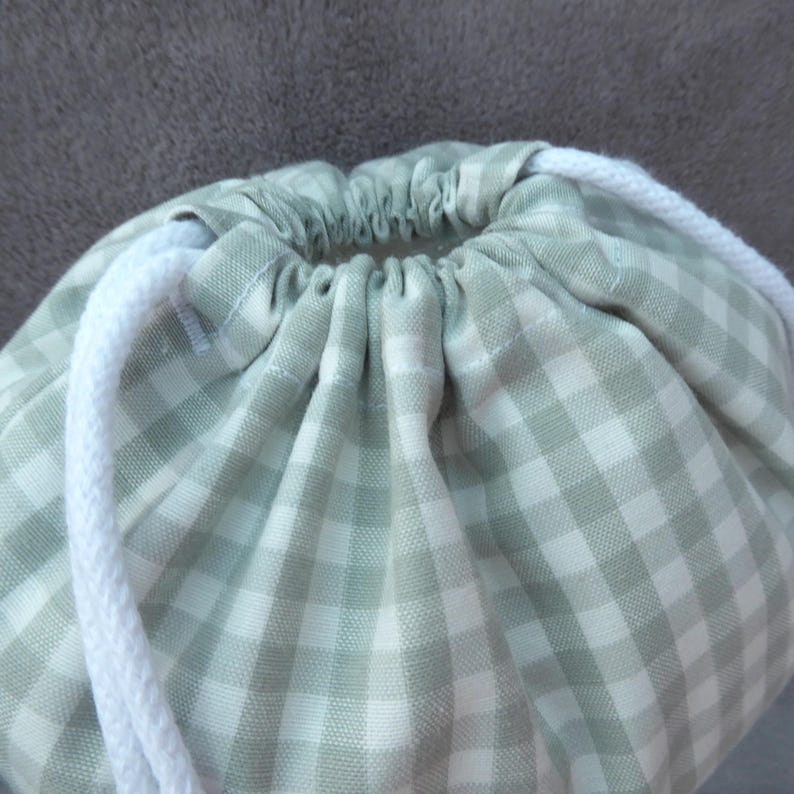 Handmade laundry bags and drawstring bags in a blue gingham cotton rich canvas fabric pull up with white cotton braided cords.