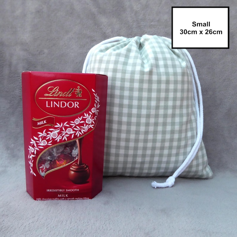 Handmade drawstring bags in a light sage green gingham cotton rich canvas fabric with white cotton braided cords.

Small with drawcord - 30cm x 26cm