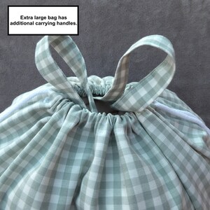 Handmade laundry bag in a light sage green gingham cotton rich canvas fabric with white cotton braided cords.

Extra large with drawcord and carry handles - 51cm x 45cm