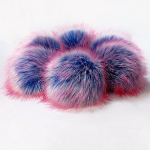 May include: Five fluffy pom poms in shades of pink and blue. The pom poms are made of faux fur and are perfect for adding a touch of whimsy to any project.