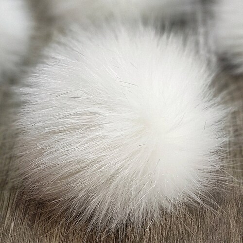 white fluffy pom pom