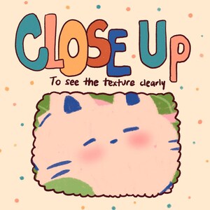 May include: A close-up image of a cartoon cat with a pink body, blue eyes, and green and blue markings. The text "CLOSE UP" is written in colorful letters above the cat. The text "To see the texture clearly" is written below the cat.